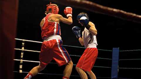 two young men boxing in a boxing ring